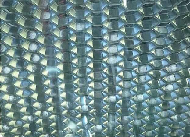 Perforated honeycomb bonded to glass