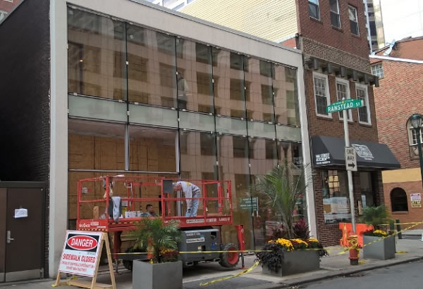 New curtain wall installation with  the sidewalk closed for pedestrian safety