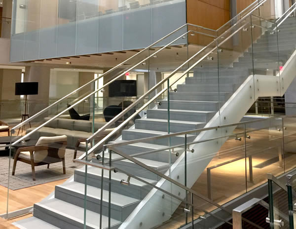Glass infill is brought down to be flush with soffit. Facility features over 2,400 ft. of custom stainless steel flat bar handrail – 825 ft. of that is wall mounted.