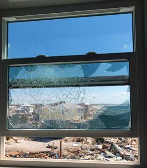Three windows suffered direct hits from windborne debris. The outer panes shattered but the Trosifol® PVB interlayer succeeded in keeping out the wind and rain.  Image © Custom Window Systems