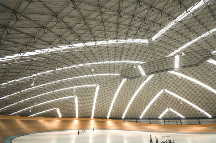 With natural light filtering in, the Velodrome accommodates cyclist sporting events and the occasional music concert.