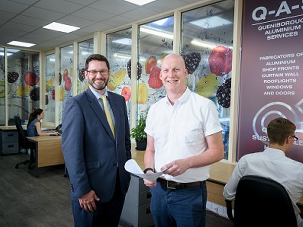 L-R Richard Green, GLASSOLUTIONS Key Account Manager, with Richard McKenzie, Commercial Manager at QAS, inside the newly created office space which is acoustically insulated thanks to an advanced specification in the sealed units.