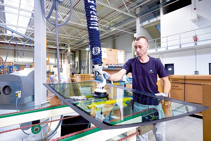 Marius Popescu prepares the sheet for the application of adhesive.