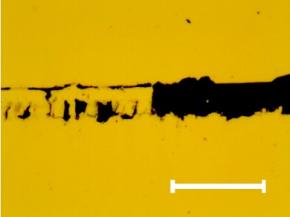 Characteristic optical image of the scratch track section where the full delamination of the chromium thin film occurs. The same fracture can be observed on the other samples. Mark size 10 μm