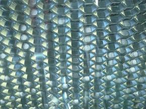 Perforated honeycomb bonded to glass