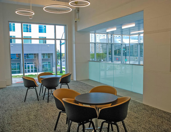 In the building’s lounge, frosted glass panels offer privacy from the lobby below, while still allowing for light to enter.