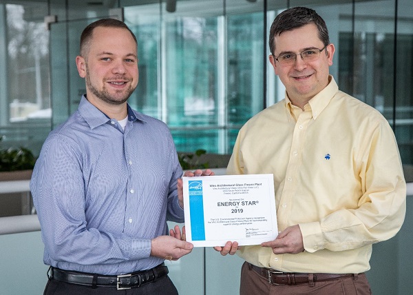 Vitro Architectural Glass employees Adam Tomaino, senior engineer (left), and Ricardo Maiz, president, receive an ENERGY STAR-labeled plant certificate for the company’s Fresno, California plant.