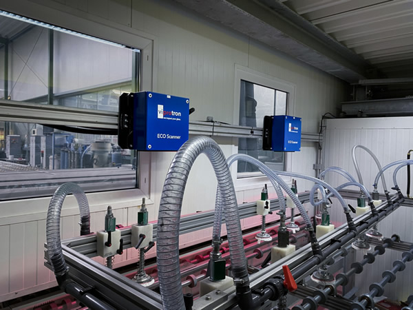 Two camera heads installed in the clean room of a lamination line.