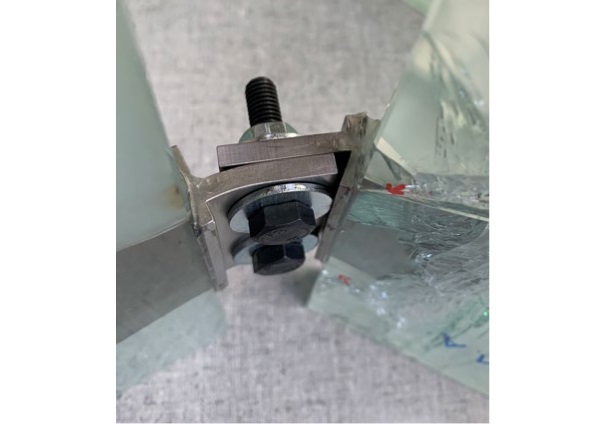 Figure 14. Detail of failed specimen in bending mode post testing. Large deformation of the fitting occurred prior to glass breakage.