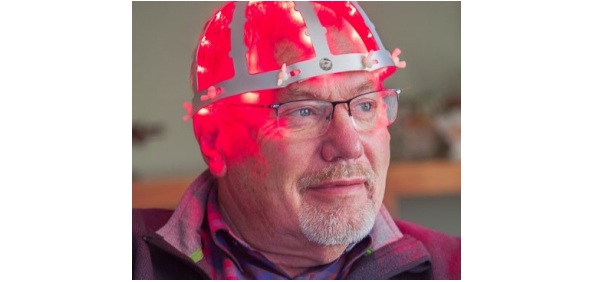 Fig. 17: Patient with "light helmet" delivering pulses of near-infrared (NIR) light directly to the substantia nigra, a brain region that degenerates in Parkinson's disease. From (Sinha, 2020).