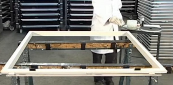 Fig. 1 Step 1 – Frame is positioned horizontally on a working bench.