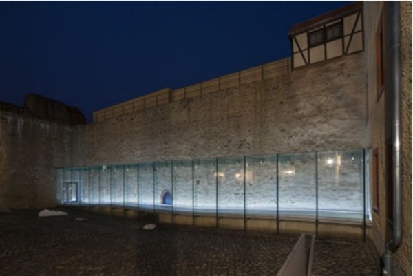 Figure 1:   Innovative examples of bonded glass constructions. a) Glass corridor with adhesively-bonded frames in the ancient castle of Grimma (Photo: Steffen Spitzner),