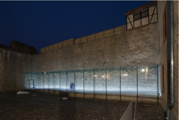 Figure 1: Innovative examples of bonded glass constructions. a) Glass corridor with adhesively-bonded frames in the ancient castle of Grimma (Photo: Steffen Spitzner),