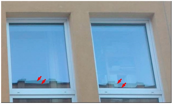 Figure 2. Visible distorted reflection of the image of the neighboring building from both insulating glass unit (IGU) component glass panes indicates the concave form of deflection of the unit.