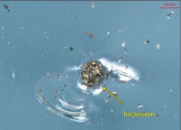 Fig. 2: Inclusion in glass fragment fracture surface.