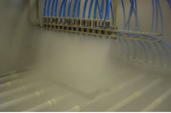 Fig. 2 Glass in water mist tempering in a laboratory test.