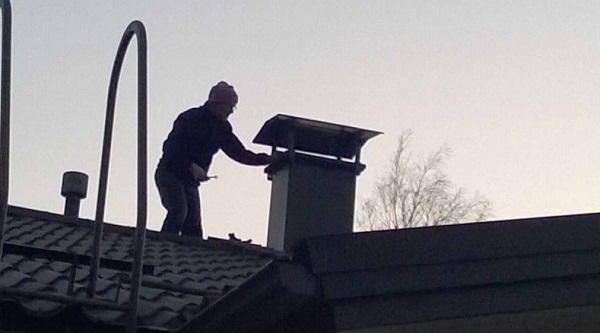 Figure 2. Assembling the chimney cover [Photo: Olavi Uusitalo].