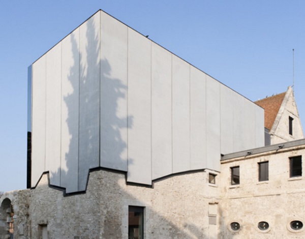 Figure 2a. The new façade of Louviers Music School (France) was restored using prefabricated reinforced concrete panels, cut out to follow the surface of the historic masonry showing the distinct boundary between the old and the new (Dent 2012). 
