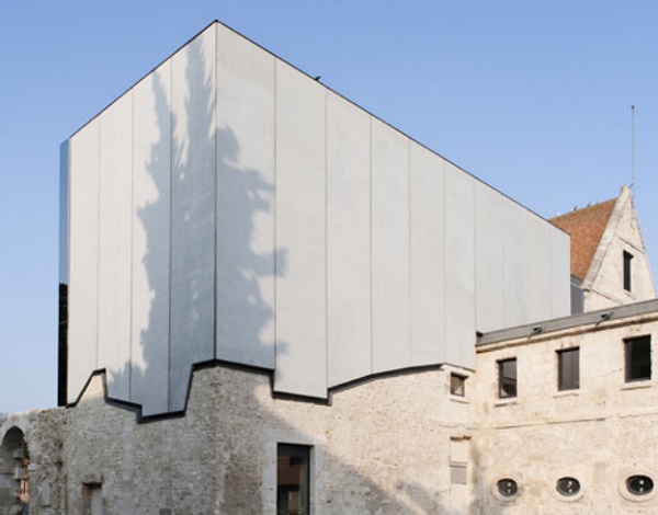 Figure 2a. The new façade of Louviers Music School (France) was restored using prefabricated reinforced concrete panels, cut out to follow the surface of the historic masonry showing the distinct boundary between the old and the new (Dent 2012).