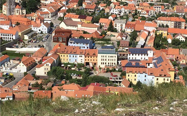 Figure 4. A deterrent example of photovoltaics use (high remote visibility in a very sensitive context) roof-– mounted PV installations on residential block in the urban conservation area of Mikulov, Czech Republic, seen from protected site of Svatý kopeček . Photo: author 