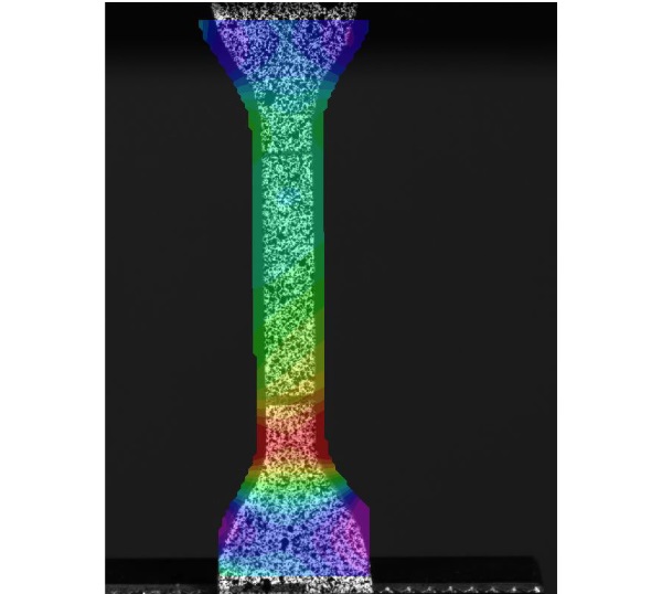 Fig. 5:   Longitudinal strain field, computed by DIC software, on the surface of a dumbbell tested in tension at 1 mm/min crosshead speed. Red and purple colours indicate high and low strain regions, respectively.