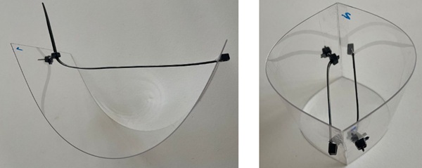 Fig. 5: Scaled model made from Perspex and tie-wraps to apply tension, so that the panes stay bent in place. The model was used to understand the principles that a thin glass connection should abide by. However, bolted connections should be avoided due to concentrated loads that the panes would not withstand.