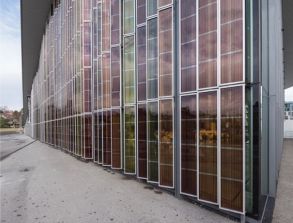 Figure 6. Convention centre in Lausanne (Switzerland), architect Richter Dahl Rocha & Associés. A newly built Centre is a part of the EPFL campus. An array of dyesensitised solar cells with green, yellow and red hues is installed on the outside of the glass fa cade. The facade functions as solar shading and produces light effects in the interior of the building. Photo: author