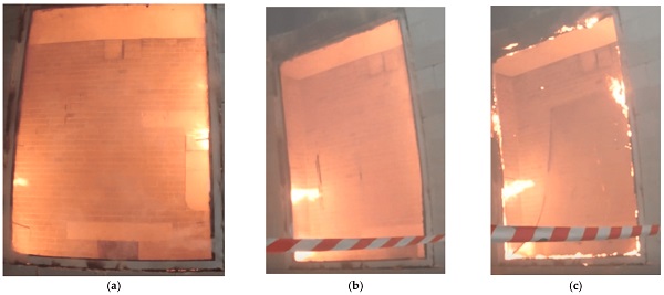 Figure 7. Large-sized sample No. 3.1 during the fire impact at (a) 48 min, (b) 57 min, and (c) 60 min. Photo by the authors.