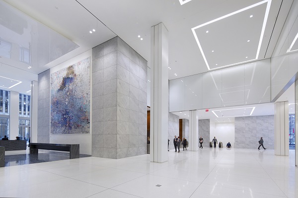 The new lobby appears gleaming white, using high-quality materials.