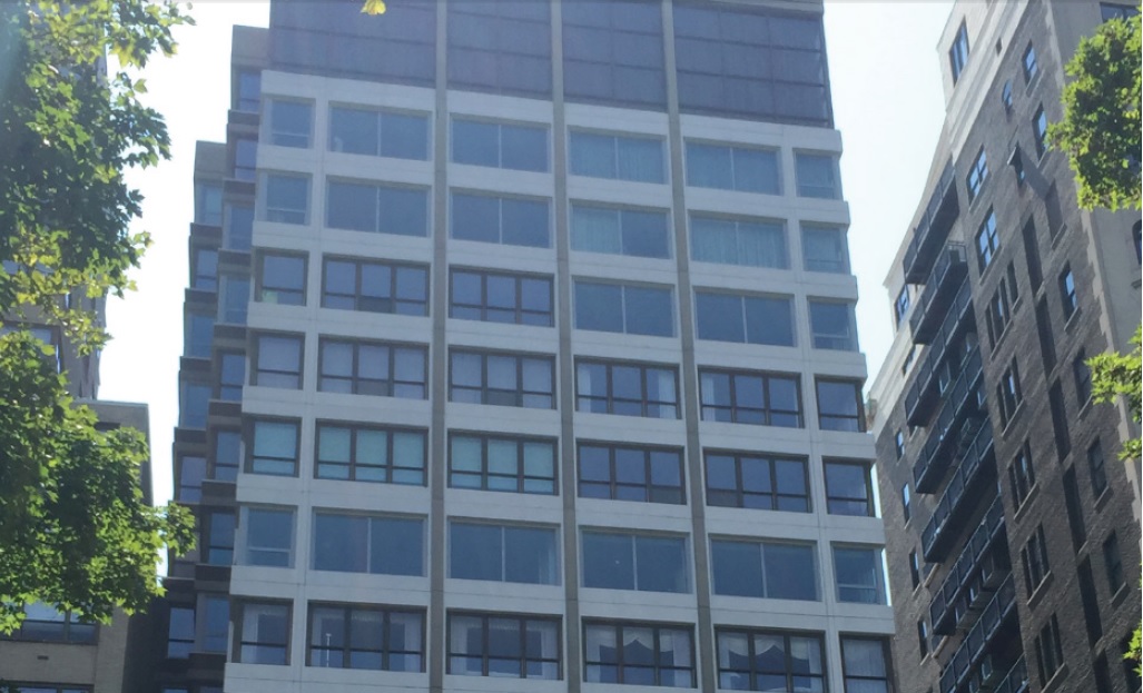 1820 Rittenhouse Square replacement in progress: the black-framed double-hung windows were replaced with the gray-framed awning windows (image courtesy GMI Contractors, Inc.)