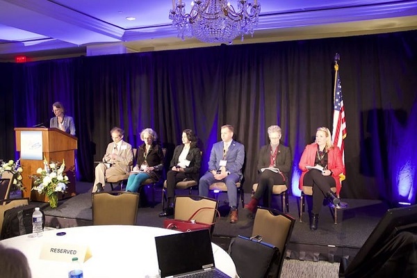 Corning’s Chris Heckle leads a panel discussion of leaders from academia, art, and industry. Panelists from left: Himanshu Jain, Lehigh University; Judith Schaechter, Tyler School of Art, Temple University; Anuradha Agarwal, Massachusetts Institute of Technology; Scott Cooper, Owens-Illinois; Jacquelyn Fetrow and Adele Schade, Albright College. Credit: ACerS