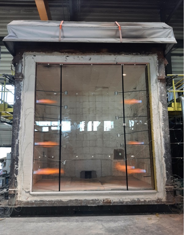 Large-format POLFLAM BR EI 120 fire-resistant glass pane during the first minutes of testing in the Gryfitlab laboratory. High-precision control of the test furnace parameters (temperature and pressure) allows for an accurate simulation of conditions during a real fire.