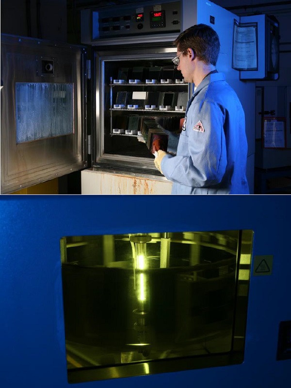 A researcher places architectural glass samples into an environmental test chamber at the Vitro Glass Technology Center in Harmar Township, Pennsylvania.