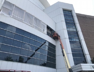 New curtain wall being cut into the facade (photo courtesy of Rabinowitz Glass)