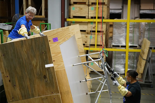 Corning employees prepare glass sheets for finishing.