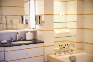 The glass shelving gives some extra storage space above the bath.