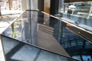 The tables are made of the same glass as the café walls.