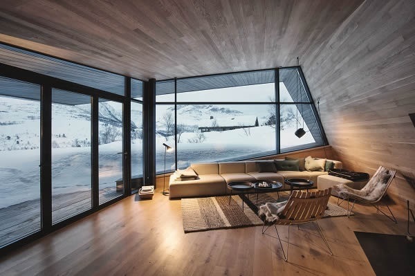 Photo Credits: Invit Arkitekter, Ålesund // Photographer: Johan Holmquist In the living room area, the Schüco FW 50+.SI façade system combines with folding sliding system Schüco ASS 70 FD to enable panoramic views and direct access to the terrace on warmer days.