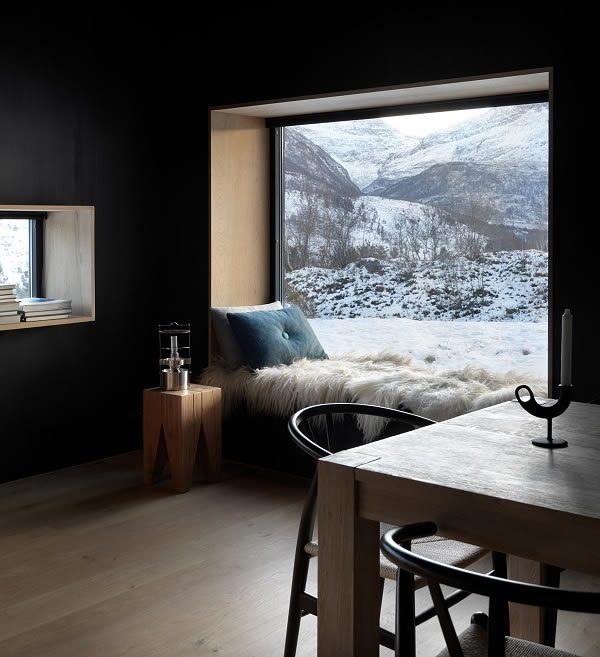 Photo Credits: Invit Arkitekter, Ålesund // Photographer: Johan Holmquist Cozy corner with a view: without energy losses, the seasonal dynamics of nature become a decorative picture (façade system Schüco FW 50+.SI).
