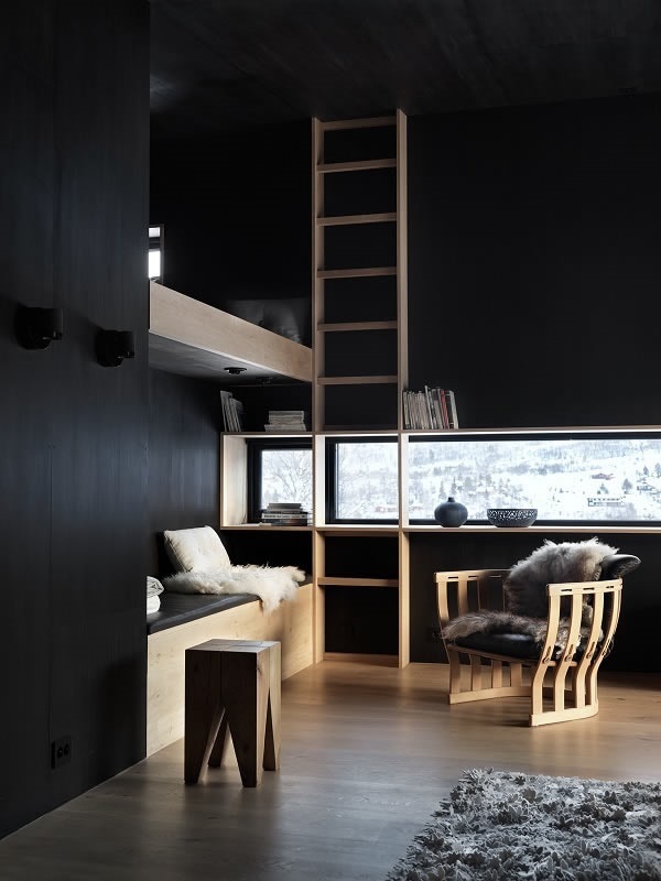 Photo Credits: Invit Arkitekter, Ålesund // Photographer: Johan Holmquist Contrasts in light, materials and colours: slim horizontally and vertically arranged windows cut out the black painted timber shell of the interior.