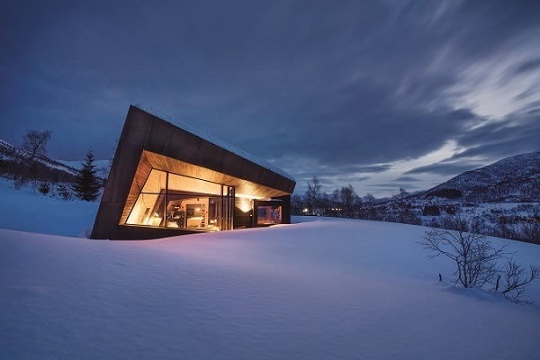 Photo Credits: Invit Arkitekter, Ålesund // Photographer: Johan Holmquist Expansive, narrowly framed glass façades combine with rusted Corten steel plates and spruce panels: the "Black Lodge" residence in Ålesund, Norway.
