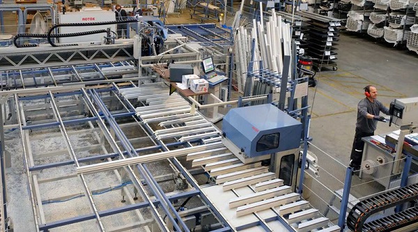 Space for efficient production organization: profile storage, processing center, the welding system in the back-ground.