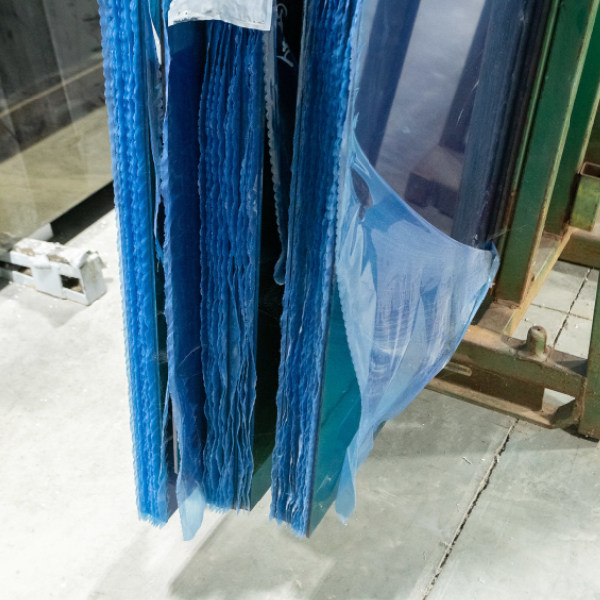 Traditional film (as seen above) adds unnecessary waste and time-consuming removal steps.  (Courtesy of Vitro Architectural Glass)