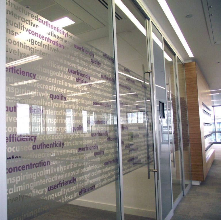 Graphics film on glazing in an office by The Window Film Company.