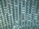 Perforated honeycomb bonded to glass