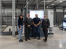 © LiSEC; LTR: Kasia Golembowska (Press Glass UK), Ged Smith (LiSEC), Lukasz Matlingiewicz (Press Glass UK), John Foster (LiSEC) in front of the GPS.autofab system and buffer shuttle