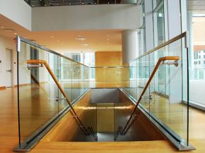 Finished wood handrails provide form and function, complementing the warm architecture of the museum.