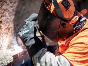 A Nortex Glass & Mirror employee wears a safety shield while working.