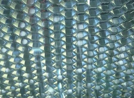 Perforated honeycomb bonded to glass