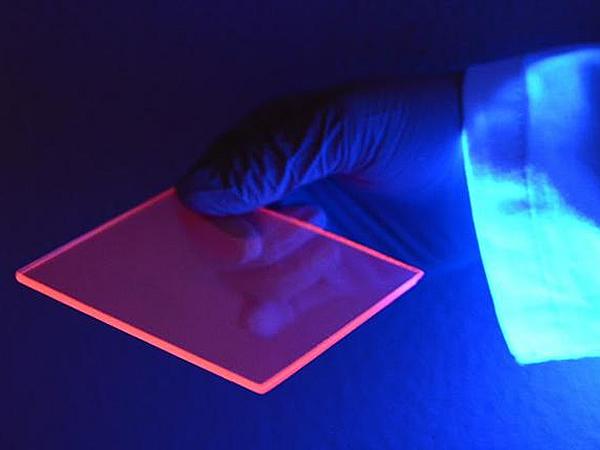 While most of the light concentrated to the edge of the silicon-based luminescent solar concentrator is actually invisible, we can better see the concentration effect by the naked eye when the slab is illuminated by a “black light” ...